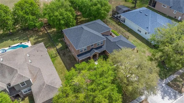 an aerial view of a house with a garden and lake view