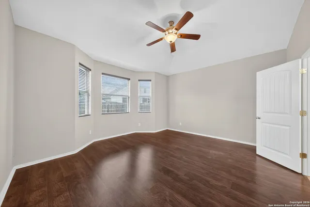 wooden floor in an empty room with a window