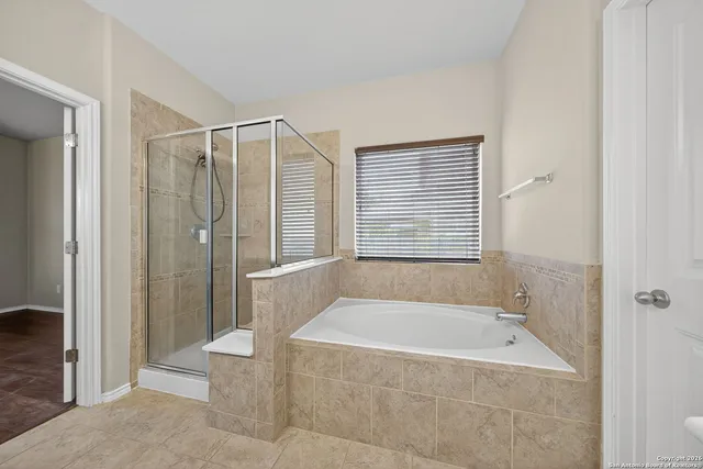 a bathroom with a bathtub and shower