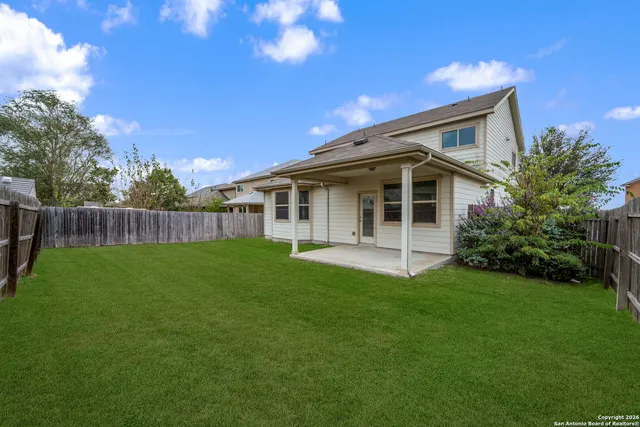 a view of an house with backyard and porch