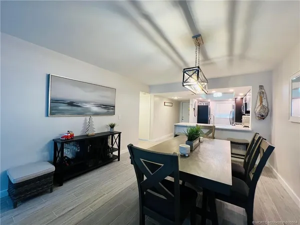 a view of a dining room with furniture and wooden floor