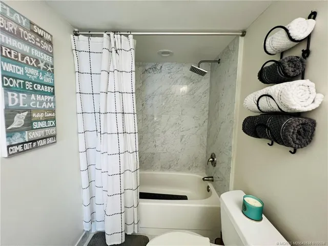 a bathroom with a shower toilet and sink
