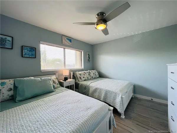 a bedroom with two beds and a window