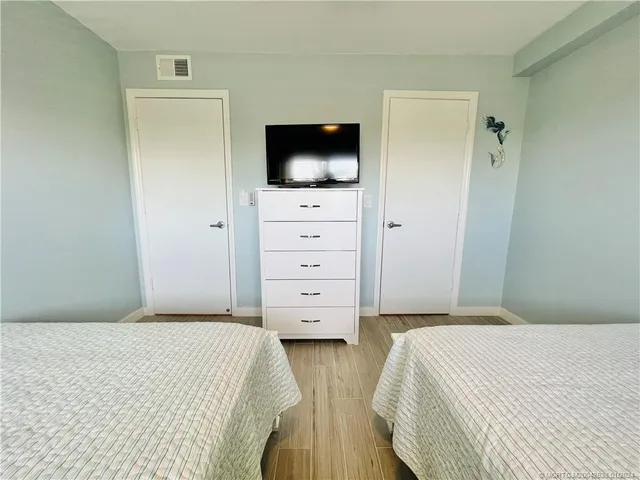 a bedroom with a flat screen tv and a bed