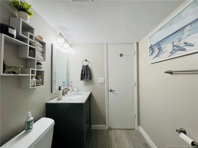 a bathroom with a sink toilet and mirror
