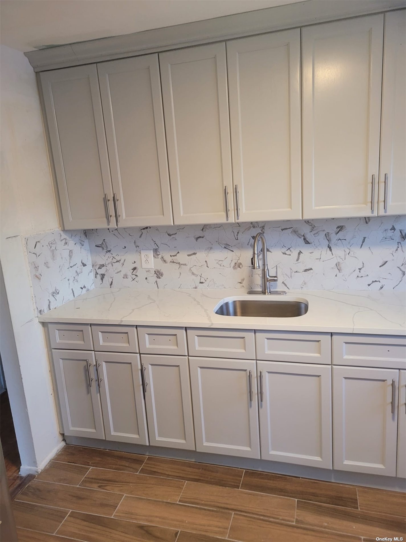 a view of a kitchen with granite countertop white cabinets