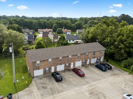 an aerial view of a house with garden space and street view