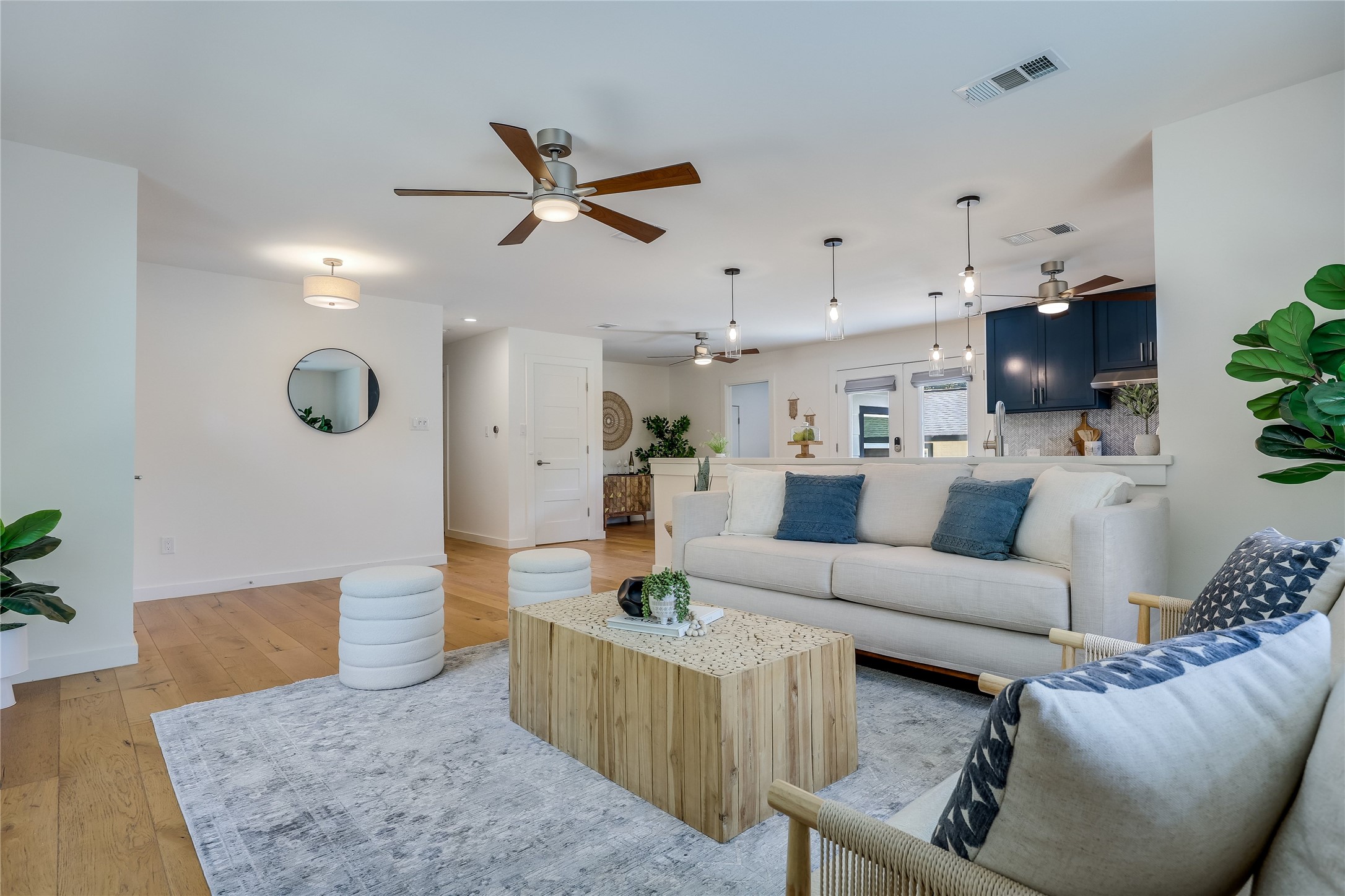 5203 Ledesma Road Austin, TX 78721 - Photo 7 of 40 An inviting open-concept living area with lustrous hardwood floors flows seamlessly into the modern kitchen.