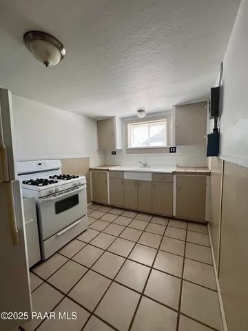 a kitchen with a cabinets a sink and a stove top oven