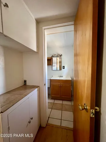 a room with a sink and a washing machine in a room