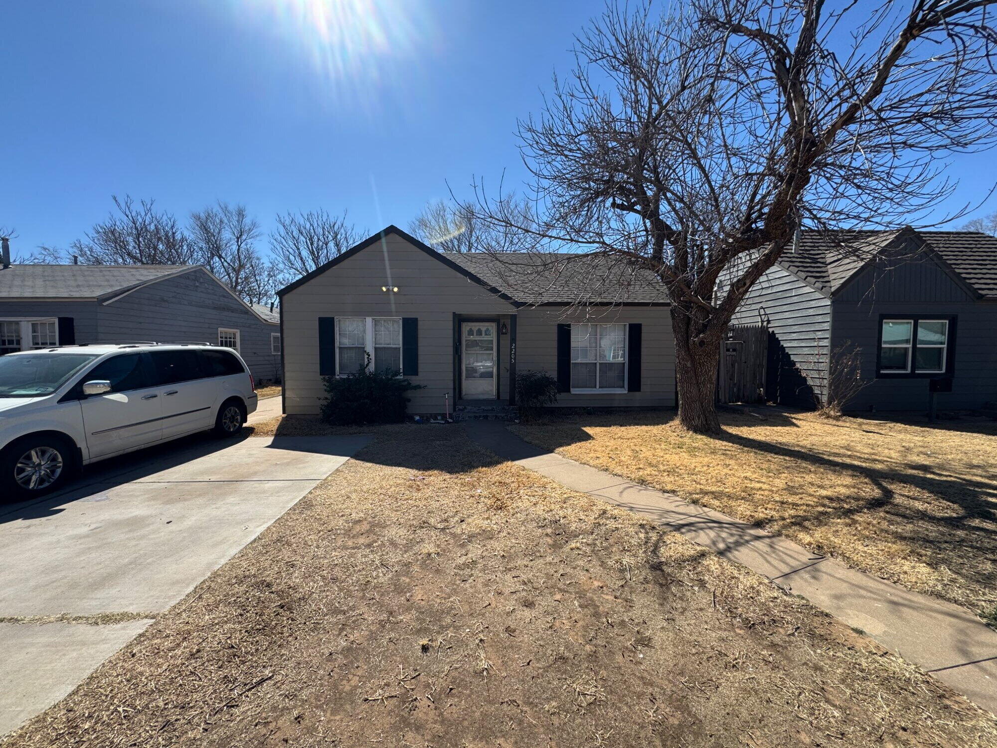 2205 25th Street, Unit FRONT Lubbock, TX 79411 - Photo 1 of 17 a front view of a house with a yard covered in snow