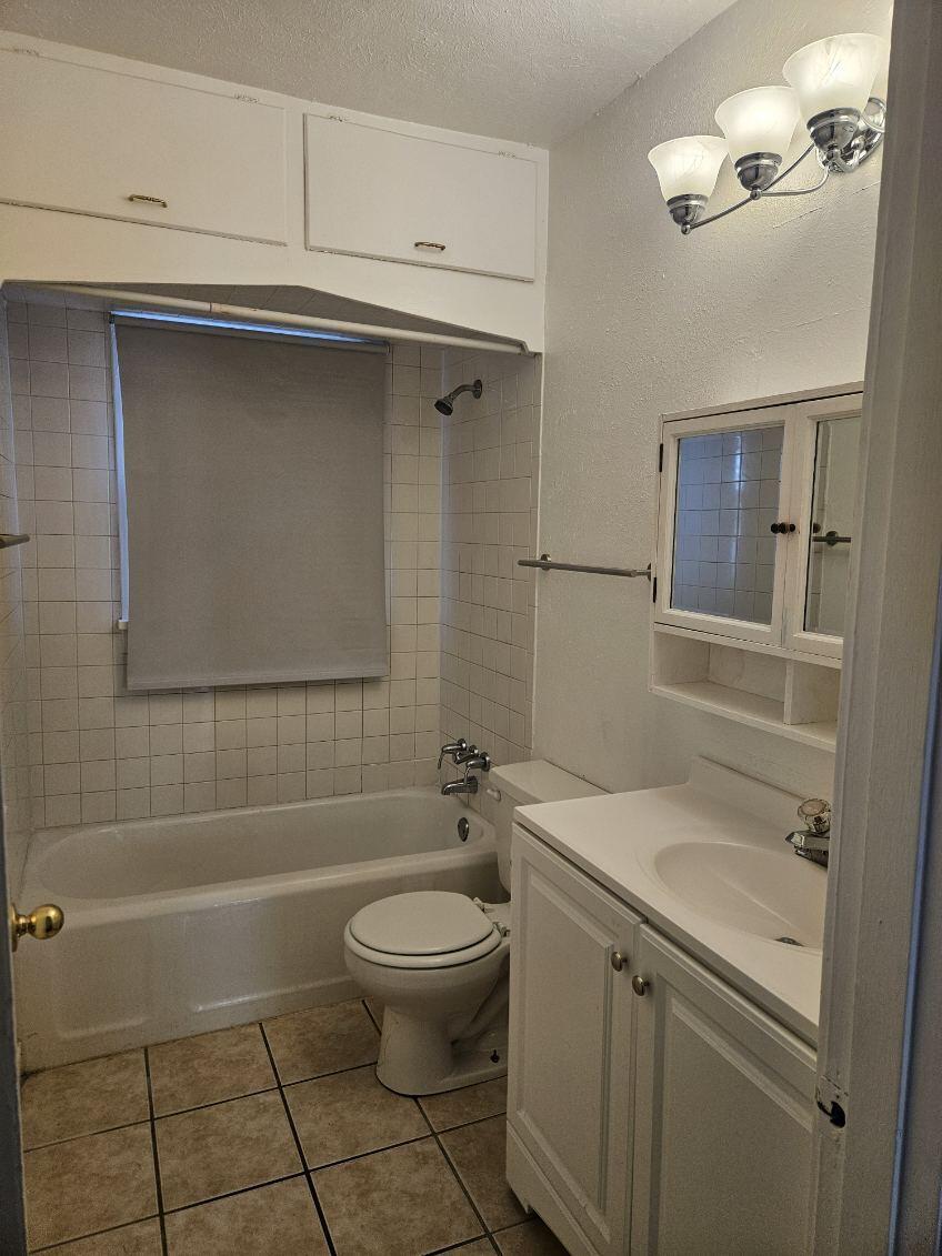 2205 25th Street, Unit FRONT Lubbock, TX 79411 - Photo 11 of 17 a bathroom with a sink a toilet and shower