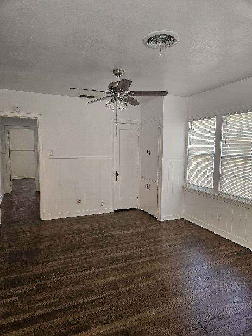 2205 25th Street, Unit FRONT Lubbock, TX 79411 - Photo 13 of 17 wooden floor in an empty room with a window