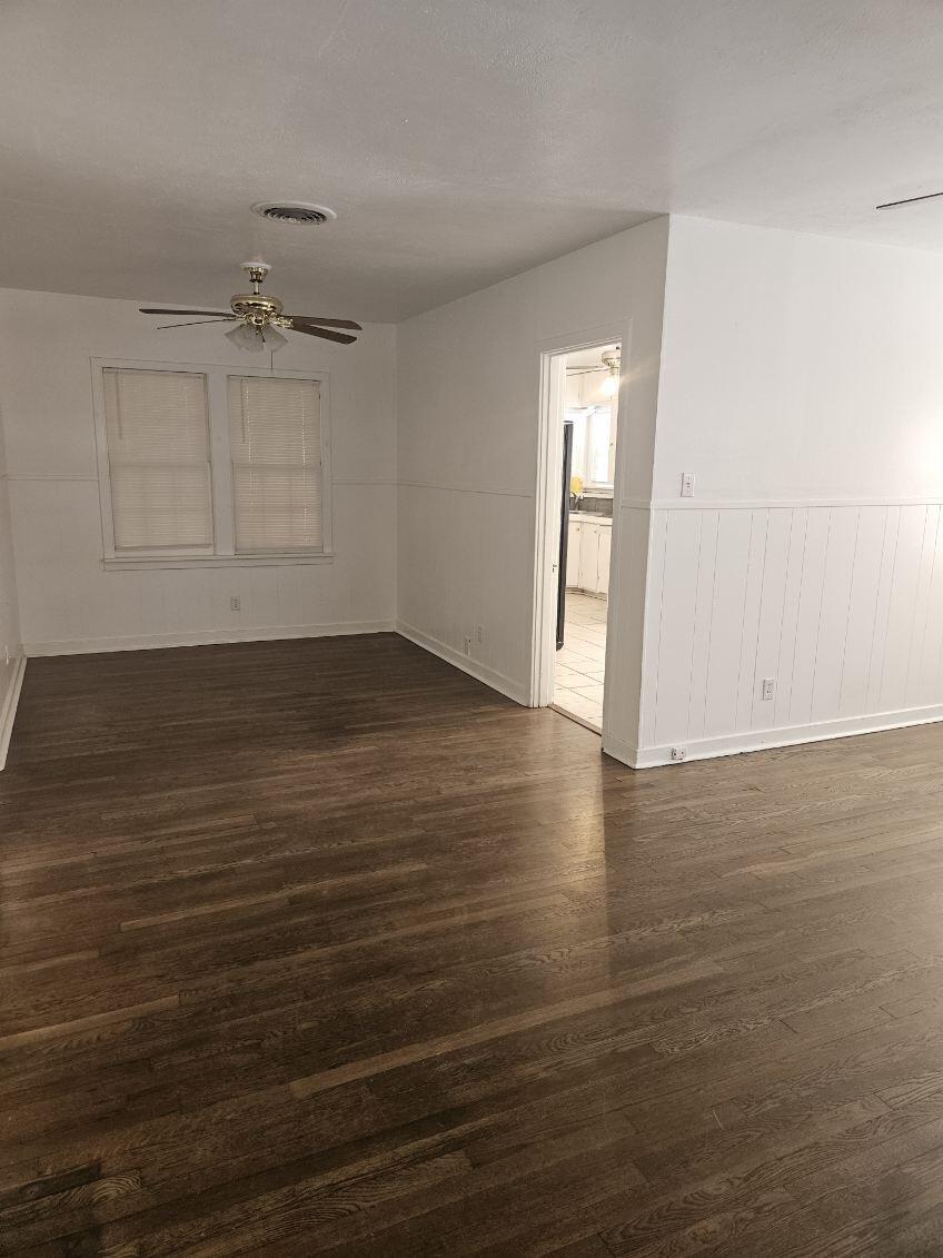 2205 25th Street, Unit FRONT Lubbock, TX 79411 - Photo 3 of 17 an empty room with wooden floor and windows