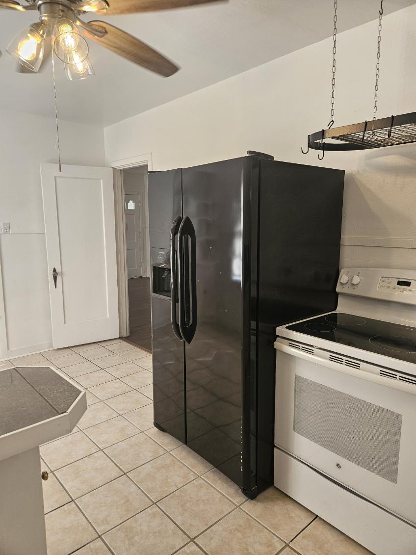 2205 25th Street, Unit FRONT Lubbock, TX 79411 - Photo 6 of 17 a kitchen with a refrigerator and cabinets