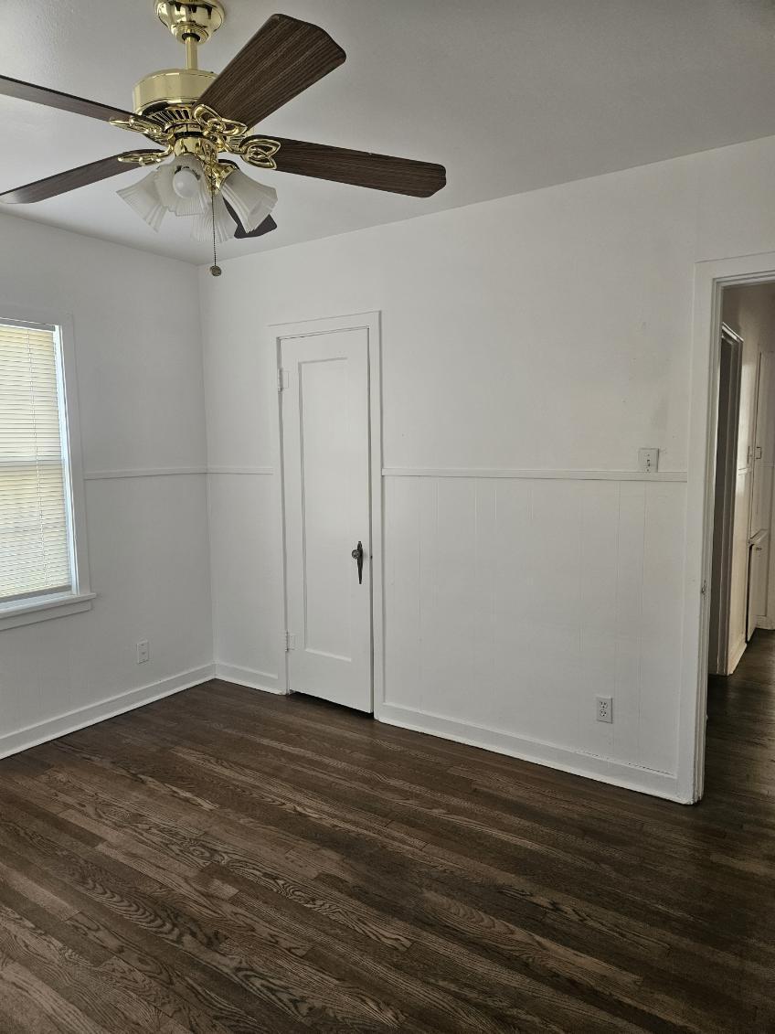 2205 25th Street, Unit FRONT Lubbock, TX 79411 - Photo 9 of 17 an empty room with wooden floor and fan