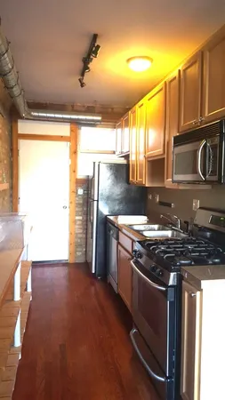 a kitchen with granite countertop a sink and a stove