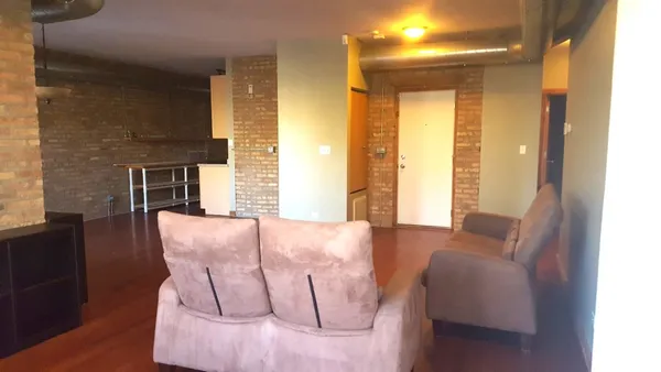 a balcony with furniture and wooden floor