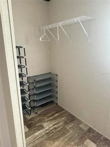 a view of walk in closet with empty racks