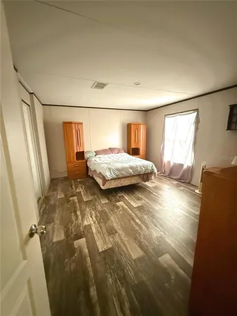 a spacious bedroom with a bed and a window