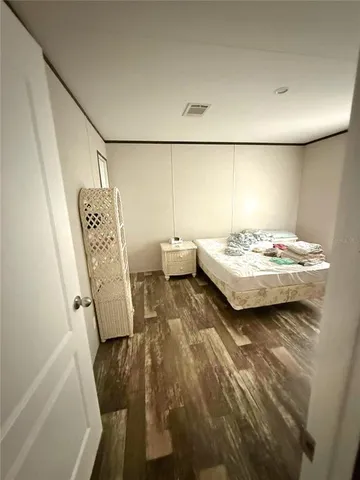 a living room with baby crib furniture and a window