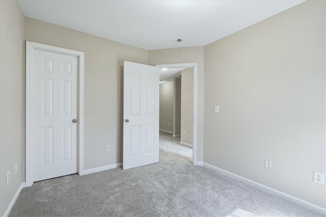 703 Bellview Way Seneca, SC 29678 - Photo 15 of 23 Plush carpeting and neutral-toned walls define this versatile secondary bedroom space.
