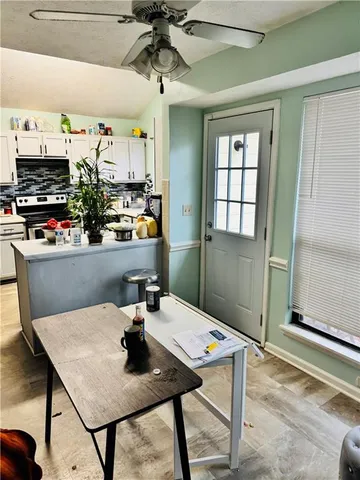 a view of a dining room with a table and chairs