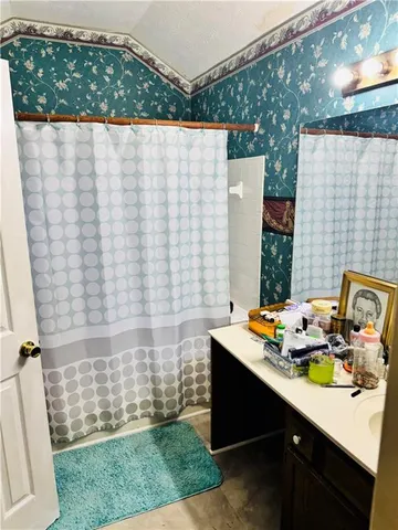 a blue curtain sitting next to a white cabinet