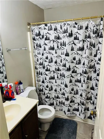 a bathroom with a sink toilet and a shower