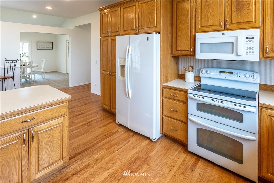 9147 Benson Road Lynden, WA 98264 - Photo 13 of 40 a kitchen with stainless steel appliances granite countertop a stove a sink dishwasher and a refrigerator