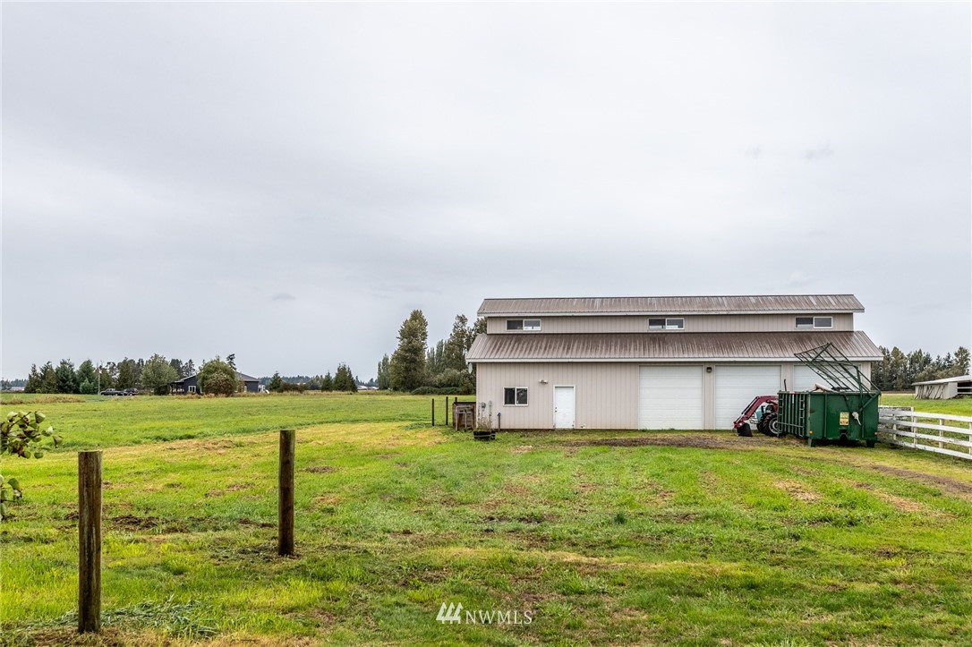 9147 Benson Road Lynden, WA 98264 - Photo 37 of 40 a view of a house with a big yard and a large tree