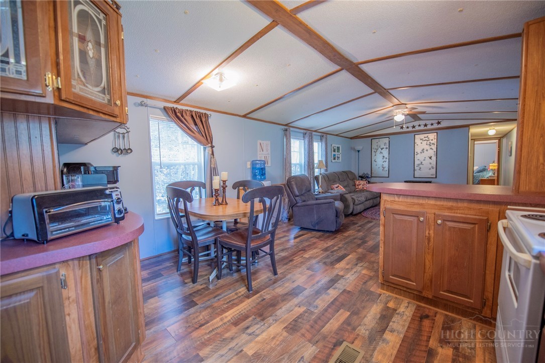 1848 West Mill Creek Road Warrensville, NC 28693 - Photo 21 of 50 a view of a dining room with furniture window and wooden floor