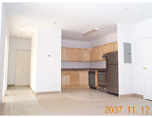 a kitchen with stainless steel appliances a refrigerator and a stove
