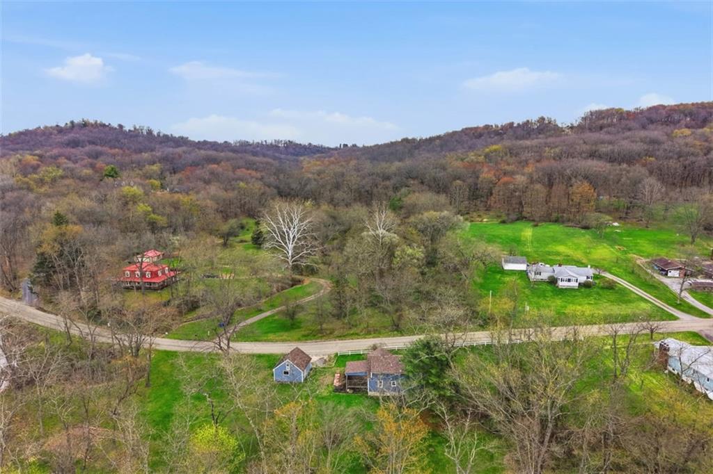192 Yellow Creek Road Harmony, PA 16037 - Photo 40 of 41 a view of a lush green hillside and a houses