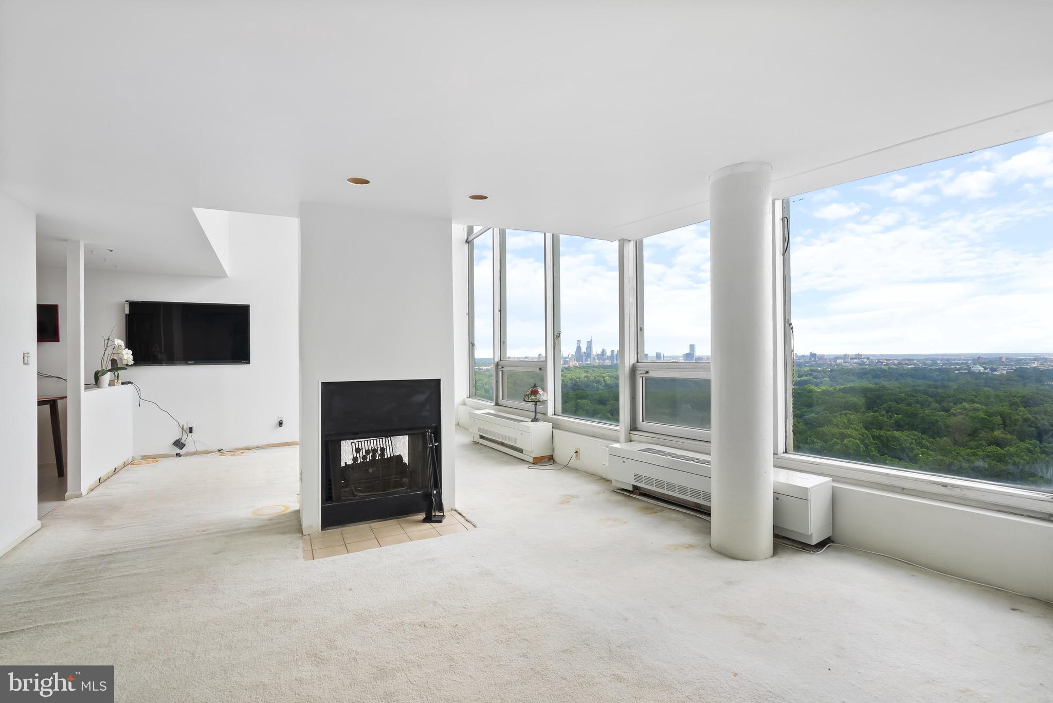 3900 West Ford Road, Unit 23C Philadelphia, PA 19131 - Photo 5 of 28 Living Room with Fireplace