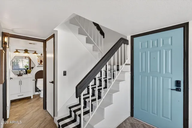 a view of staircase with lots of frames and a rug