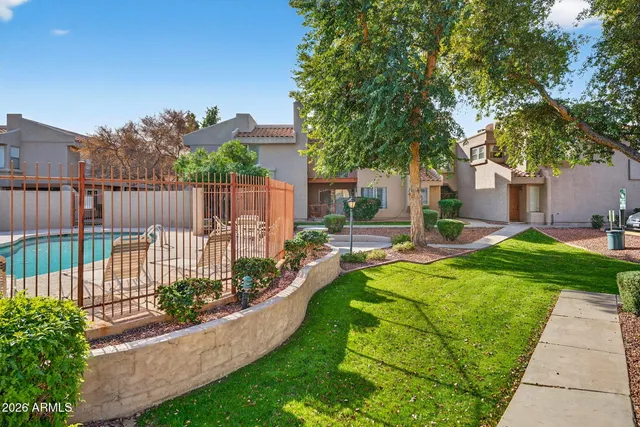 a view of a house with backyard patio and swimming pool