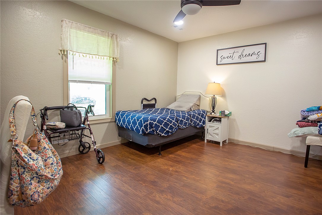 3726 St Joe Road Atkins, AR 72823 - Photo 19 of 41 Room with wood-finish flooring, a window with horizontal blinds, and a ceiling fan with integrated lighting