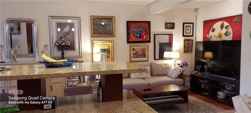 275 Webster Avenue, Unit 2K Brooklyn, NY 11230 - Photo 13 of 22 a living room with furniture and a flat screen tv