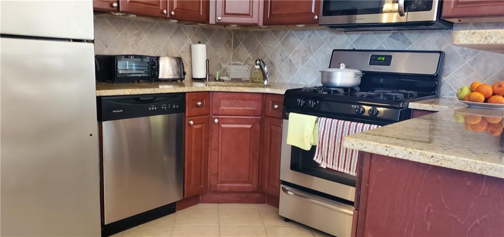 275 Webster Avenue, Unit 2K Brooklyn, NY 11230 - Photo 16 of 22 a kitchen with granite countertop stainless steel appliances and wooden cabinets
