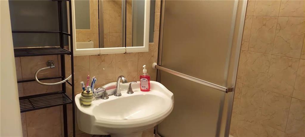 275 Webster Avenue, Unit 2K Brooklyn, NY 11230 - Photo 20 of 22 a bathroom with a sink and mirror