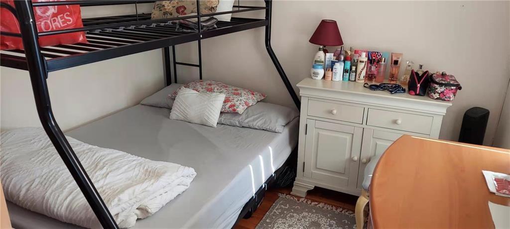 275 Webster Avenue, Unit 2K Brooklyn, NY 11230 - Photo 21 of 22 a bed room with a bed and a book shelf