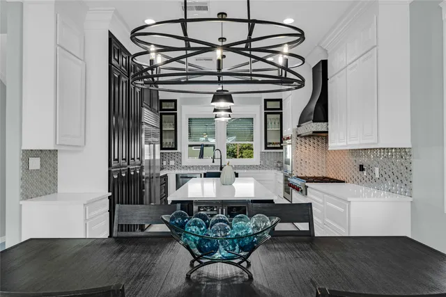 a living room with furniture a chandelier and a window