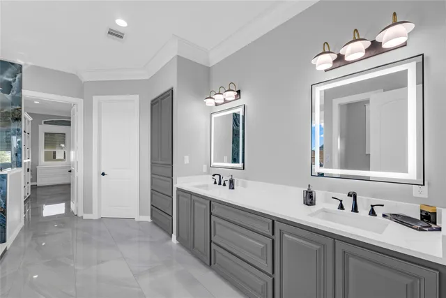 a bathroom with double vanity sinks and a mirror