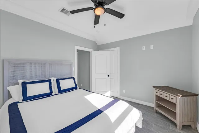 a bedroom with a bed and a ceiling fan