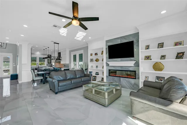 a living room with furniture a flat screen tv and a fireplace