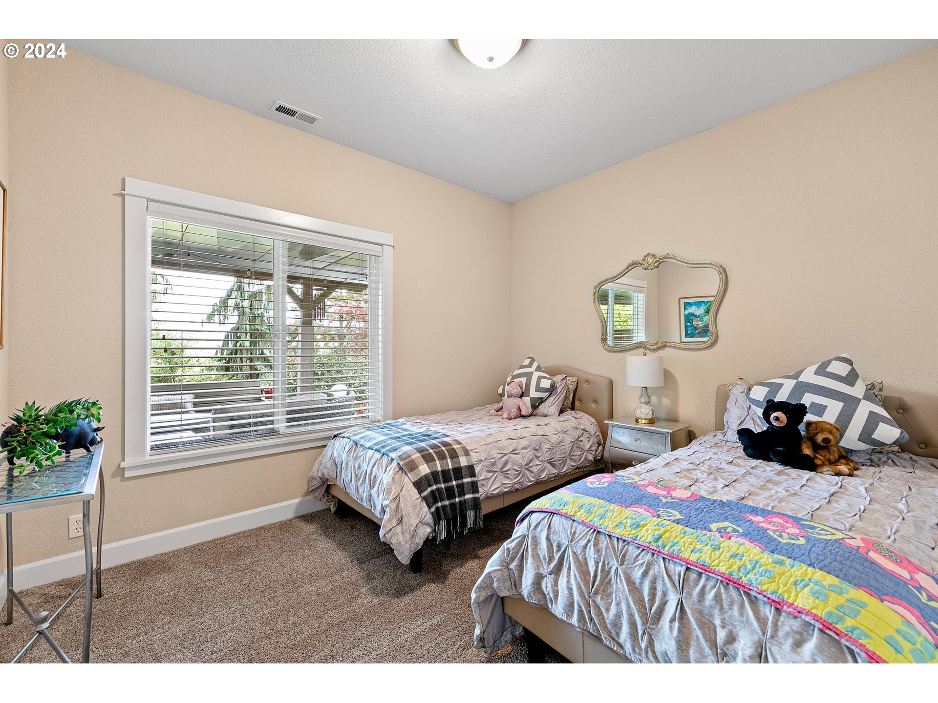3321 Bentley Avenue Eugene, OR 97405 - Photo 28 of 48 a bedroom with two beds and potted plants next to a window