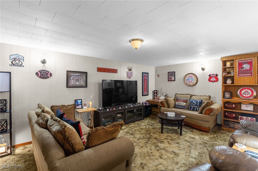 1230 Parshall Road Wellsville, OH 43968 - Photo 19 of 42 Living room with wood walls and carpet flooring