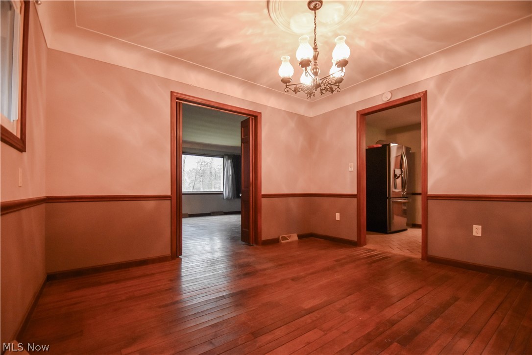 9506 Kirk Road North Jackson, OH 44451 - Photo 14 of 50 Spare room with a chandelier and dark wood-type flooring