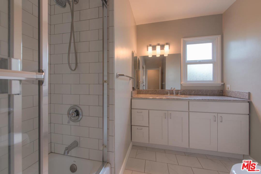 4739 Libbit Avenue Encino, CA 91436 - Photo 13 of 23 a bathroom with a sink and a mirror